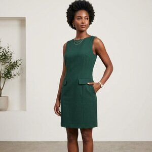 A green sheath dress with elegant flap pocket details.